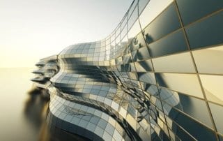 Modern building with reflective glass panels and an unusual, wavy architectural design.